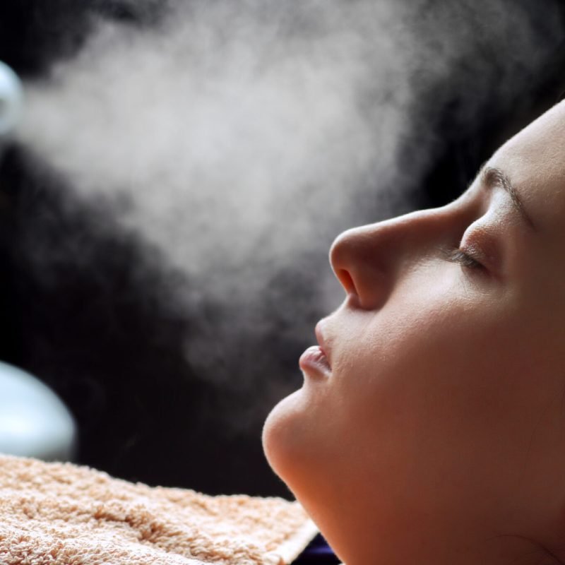 Beauty treatment of face skin with ozone facial steamer in spa center
